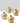 Set of three gold metallic vases on a white surface with a light gray background