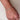 Hand wearing a diamond bracelet on a neutral background