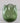 Green glass vase on a light gray background