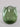 Green glass vase on a light gray background