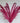 Bouquet of pink pampas grass in a white vase against a wooden background