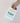 Hand holding a card with 'Congrats on making a tiny human' text against a plain background