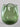 Green glass vase on a light gray background